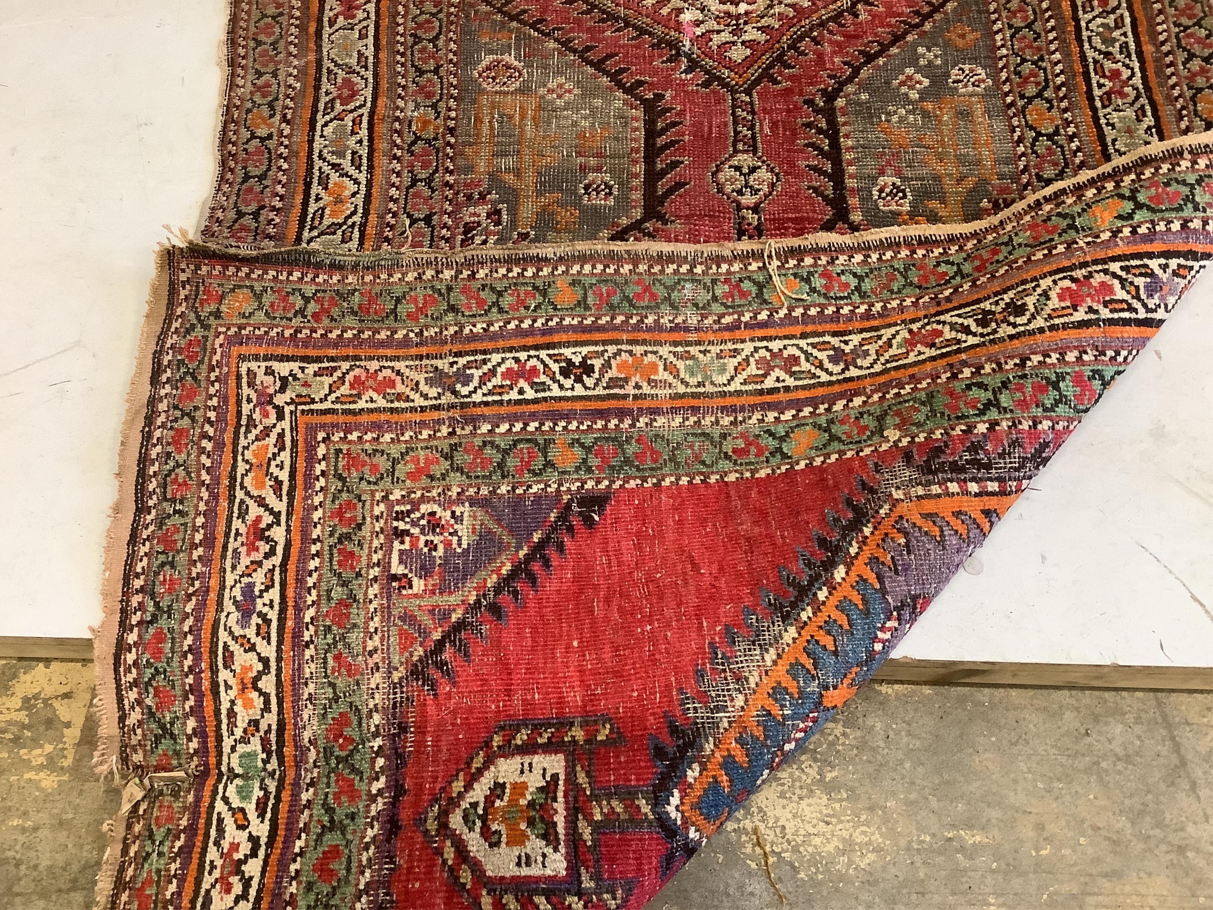 A Caucasian red ground runner, woven with a row of octagons, 416 x 106cm. Condition - fair